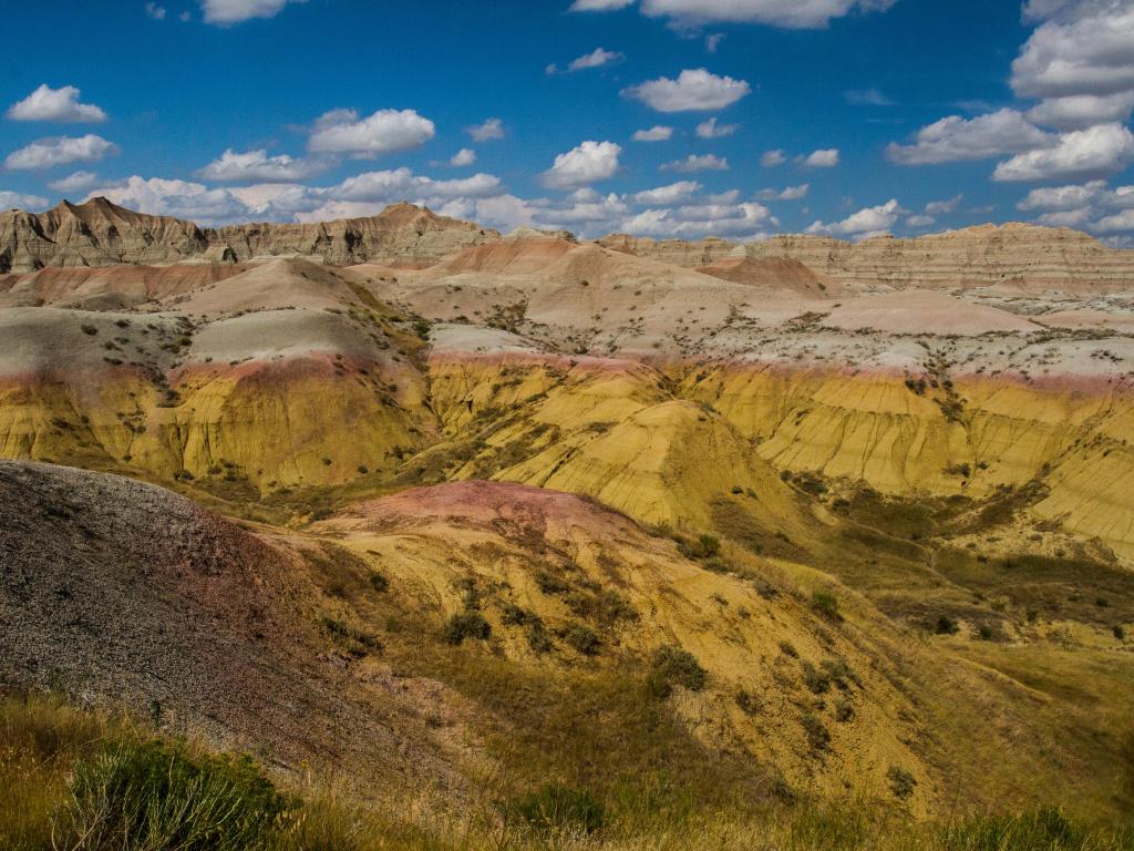 A panoramic view of the mustard-colored peaks and valleys at Yellow Mounds Overlook in Badlands National Park