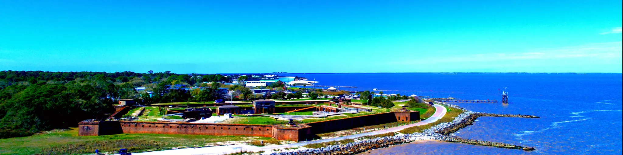 A panoramic view of a pentagon-shaped Fort Gaines along Mobile Bay in Dauphin Island, Alabama, USA, in fair weather