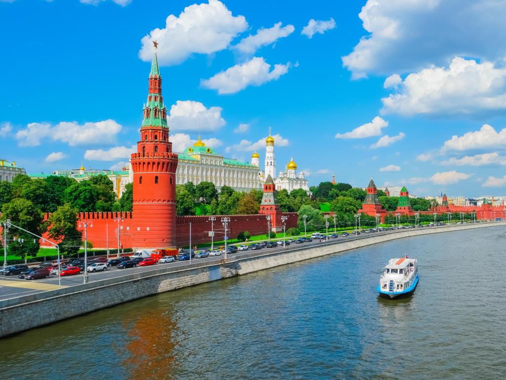 View over Moscow Kremlin with Moscow River in the forefront with boats on the river, Russia