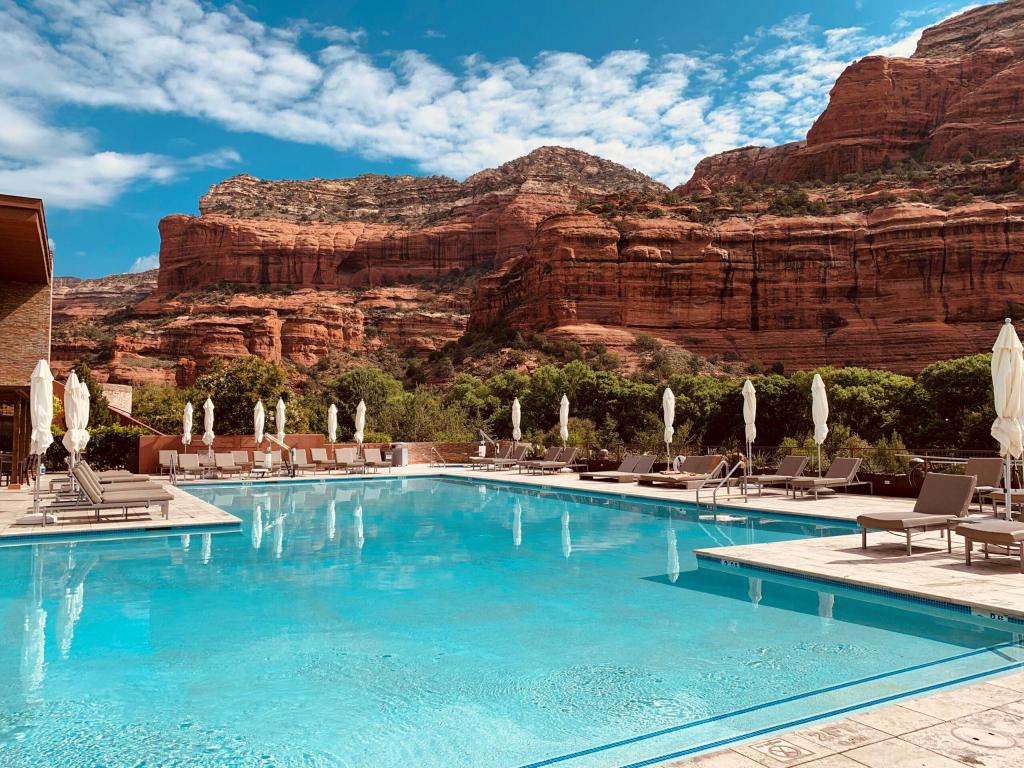 Luxury outdoor swimming pool and terrace surrounded by red rocks at exclusive Enchantment Resort