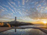 Peggy's cove lighthouse, Halifax, Nova Scotia with huge rock sunset ocean view landscape.