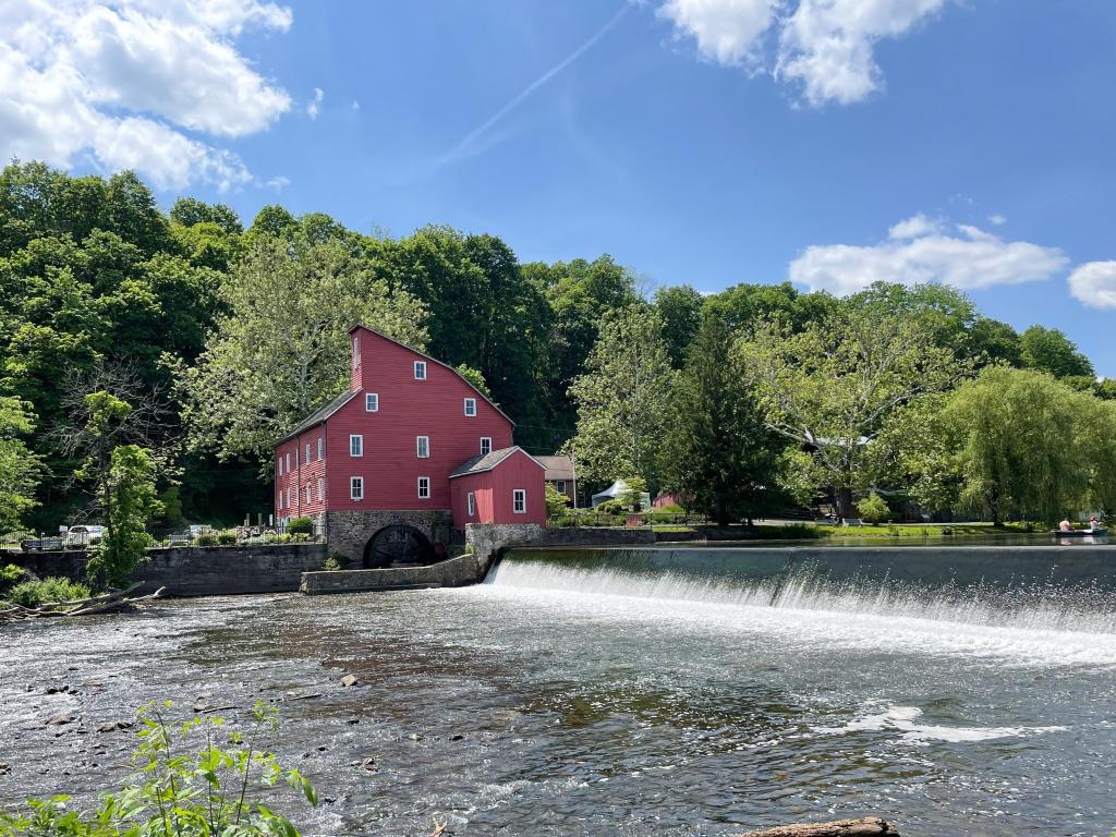 Historic Red Mill in on the river with woodland backdrop, in summer, Clinton, New Jersey