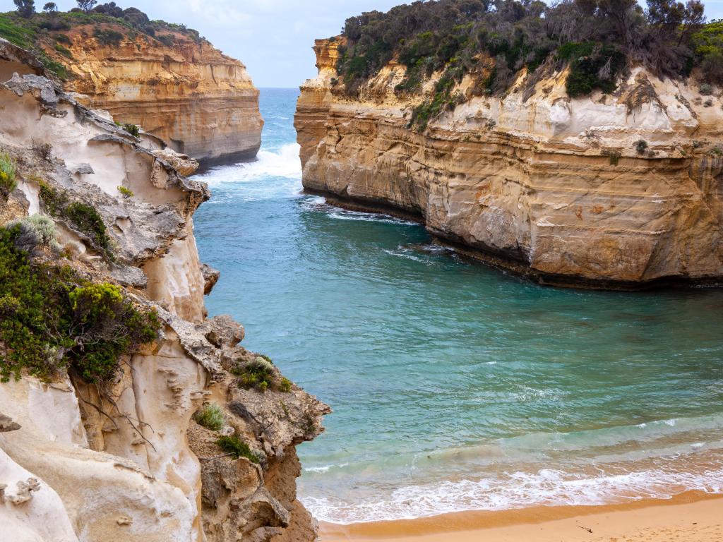 Beautiful aerial view over Loch Ard Gorge with sandy shores and blue waters, Great Ocean Road, Melbourne, Australia