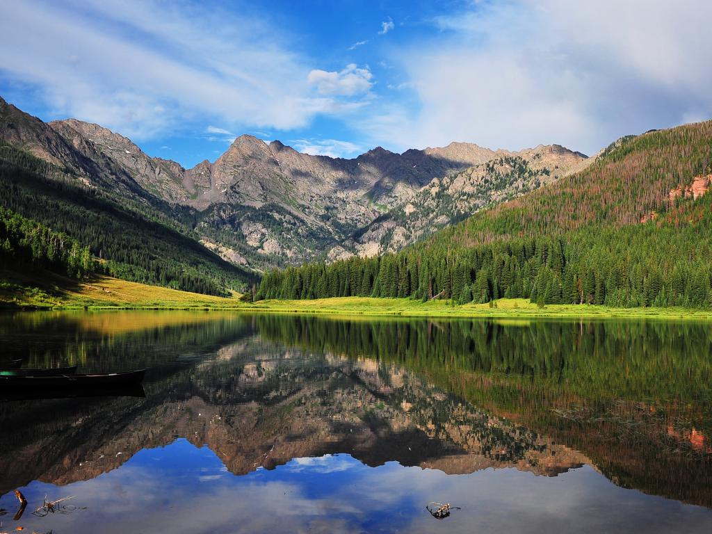 Piney Lake with mountains reflected in the water near Vail, Colorado.