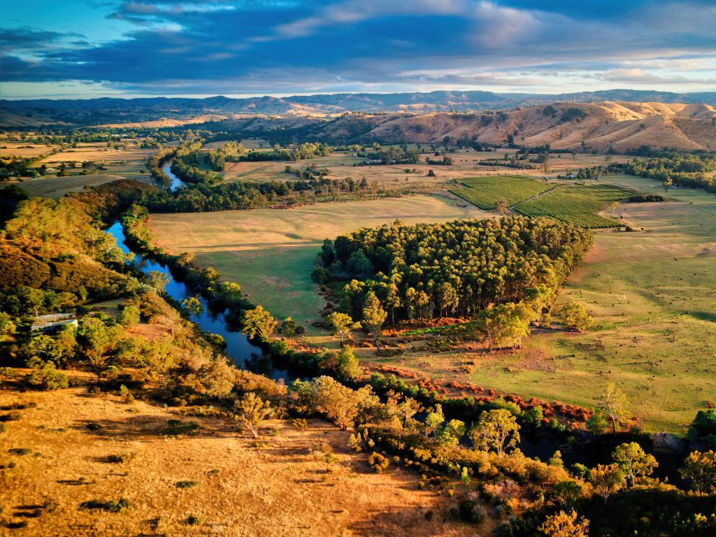 Early morning light over hills with river and undulating green farmland