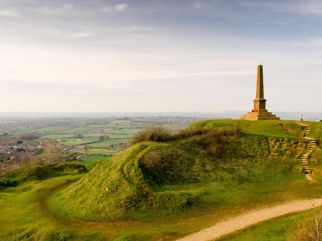A view over the Somerset Levels from Ham Hill near Yeovil, with the old quarry workings and obelisk in the foreground.