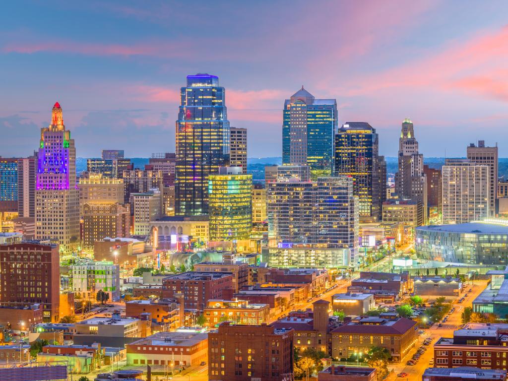 Kansas City skyline with lit-up buildings during dusk