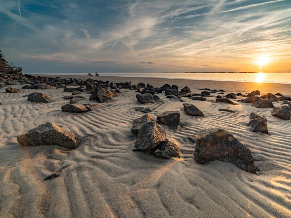 Jekyll Island, GA, USA with stunning clouds cover the sky during sunset at Jekyll Island, GA showing the beautiful beach stones.