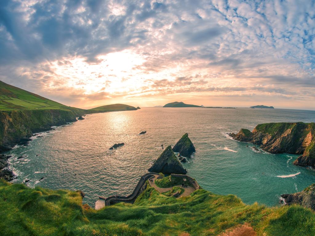 Dingle Peninsula, Kerry, Ireland taken at Dunquin Pier Harbor with cliffs and the sea at sunset.