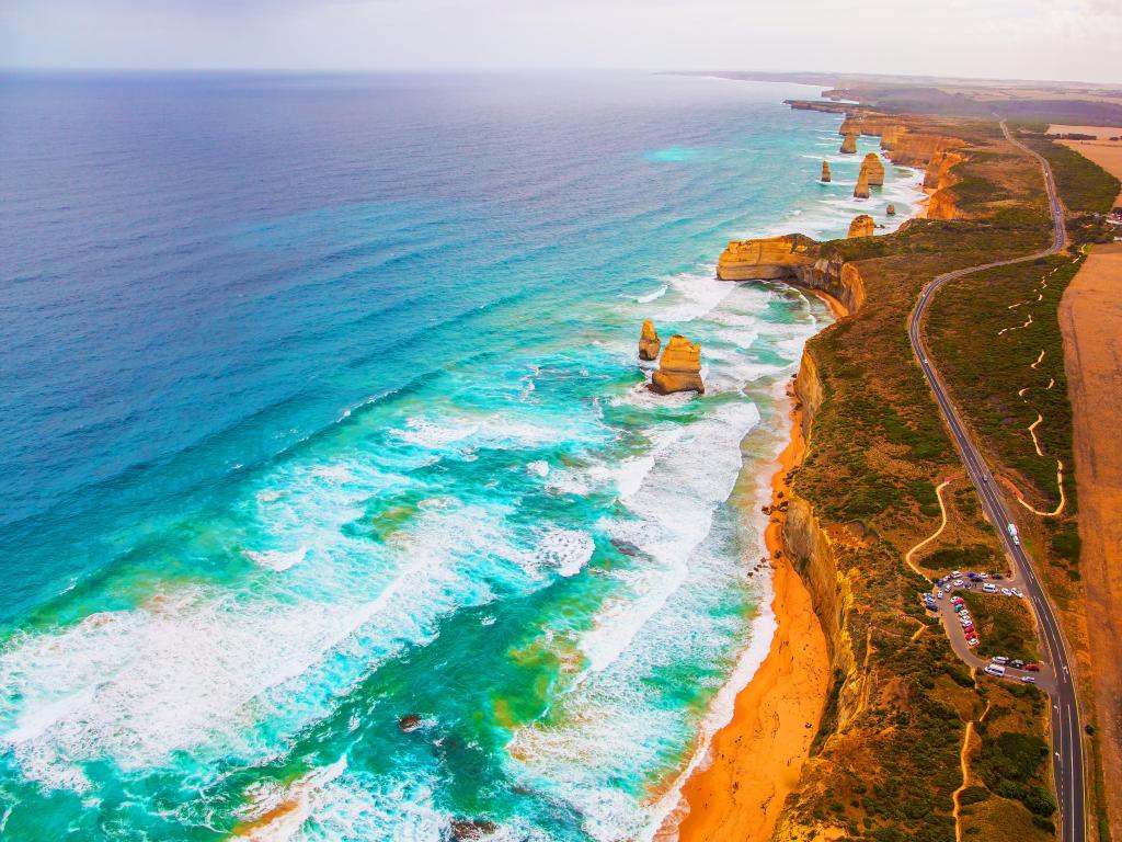 Aerial view across the Twelve Apostles limestone rocks emerged in the Pacific Ocean and Great Ocean Road, Australia