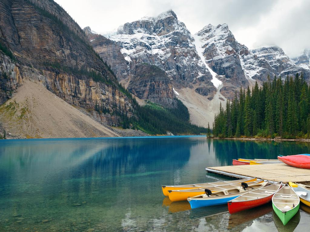 Moraine Lake and boat with snow capped mountain of Banff National Park