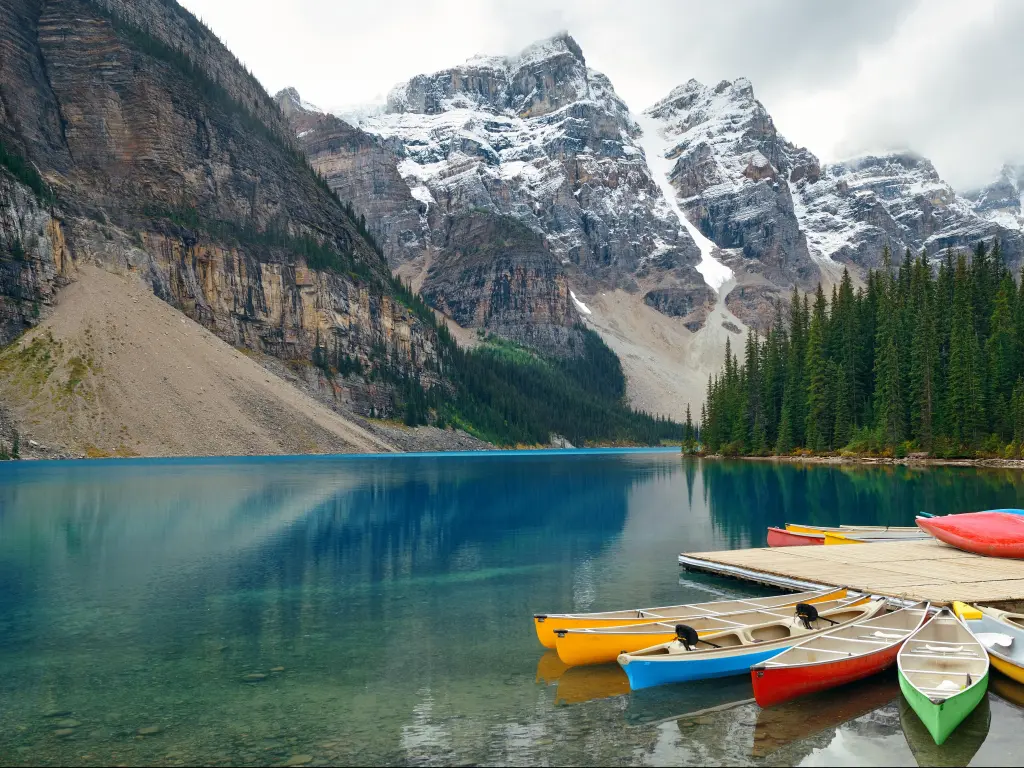 Moraine Lake and boat with snow capped mountain of Banff National Park
