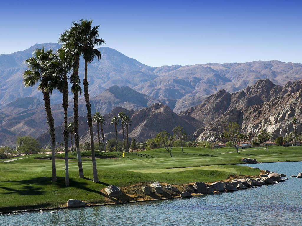 Pga West golf course in La Quinta, Palm Springs, California on a sunny day with mountains in the bachground