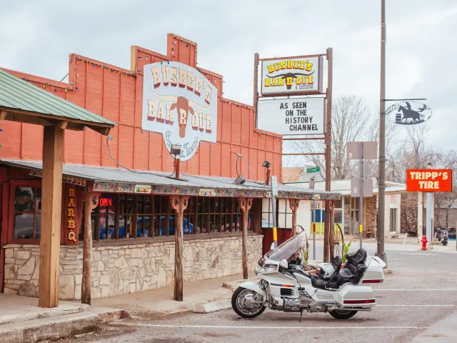 Motorbikes parked in front of a BBQ joint