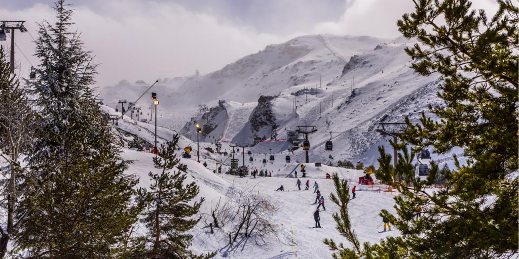 People skiing down a mountain in Sierra Nevada, Spain