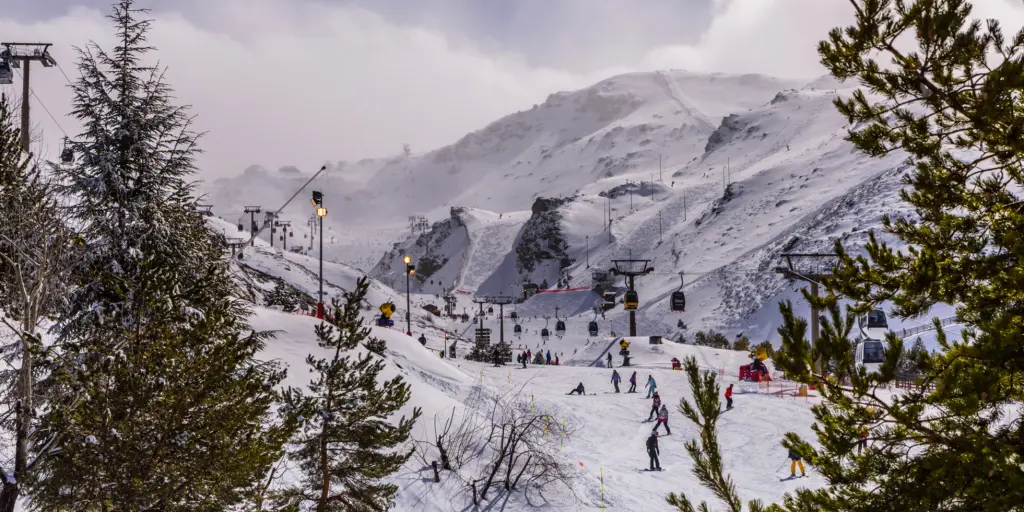 People skiing down a mountain in Sierra Nevada, Spain