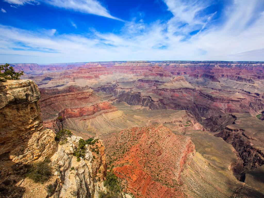 View from Yavapai Point in the Grand Canyon on a sunny day with blue sky and a few clouds