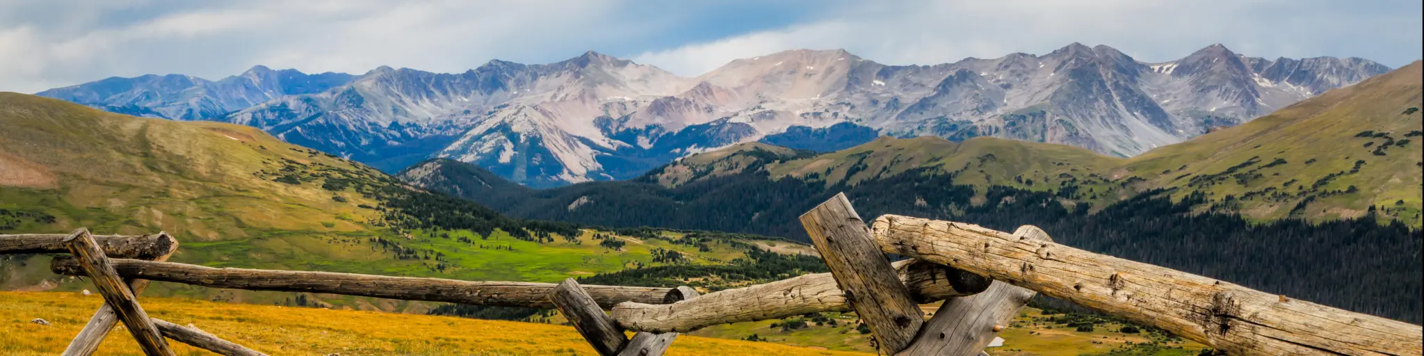 Rocky Mountains National Park, Colorado, USA with a fence in the foreground with distant mountains.
