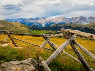 Rocky Mountains National Park, Colorado, USA with a fence in the foreground with distant mountains.