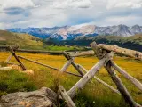 Rocky Mountains National Park, Colorado, USA with a fence in the foreground with distant mountains.