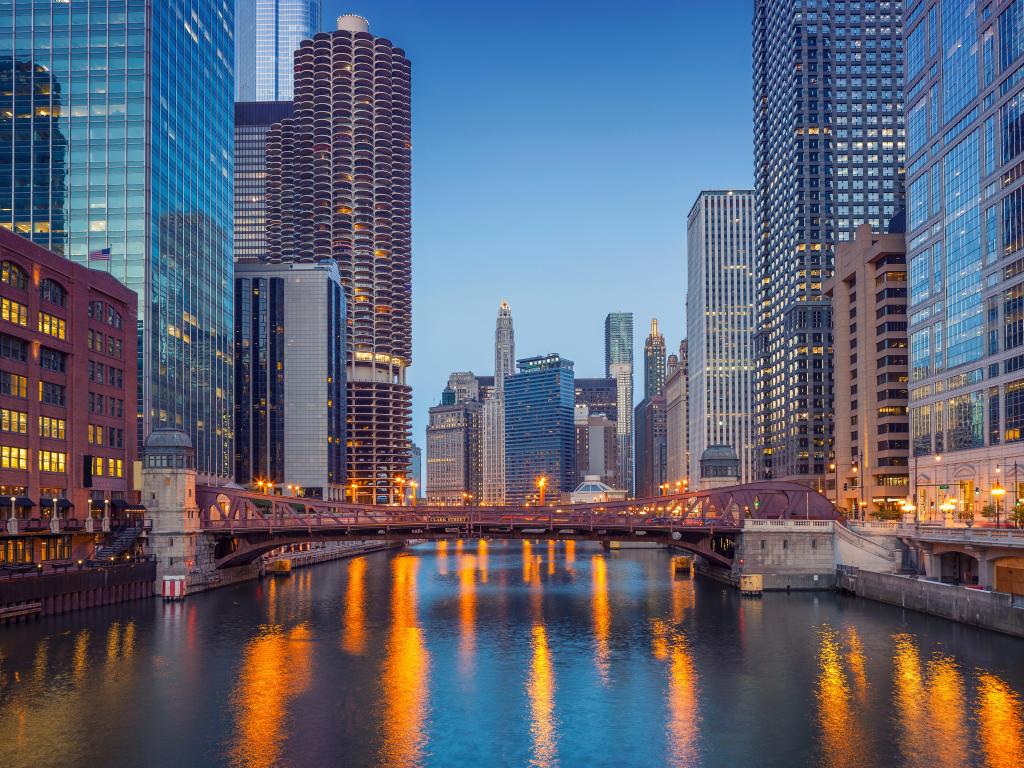 Downtown Chicago at twilight blue hour with lights reflecting on the water 