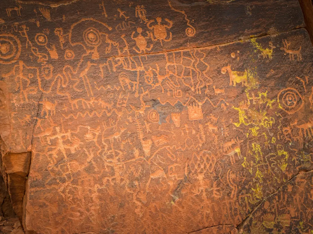 Historic petroglyphs on red rock surface