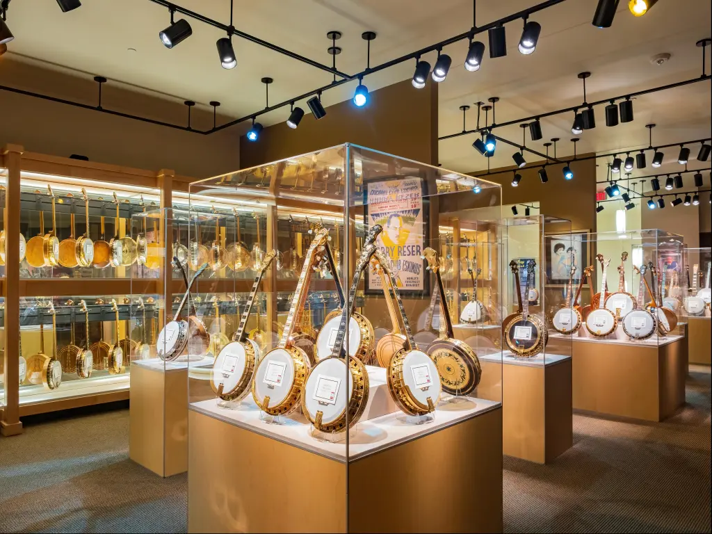 Dozens of banjos on display behind glass in the America Banjo Museum in Oklahoma City 