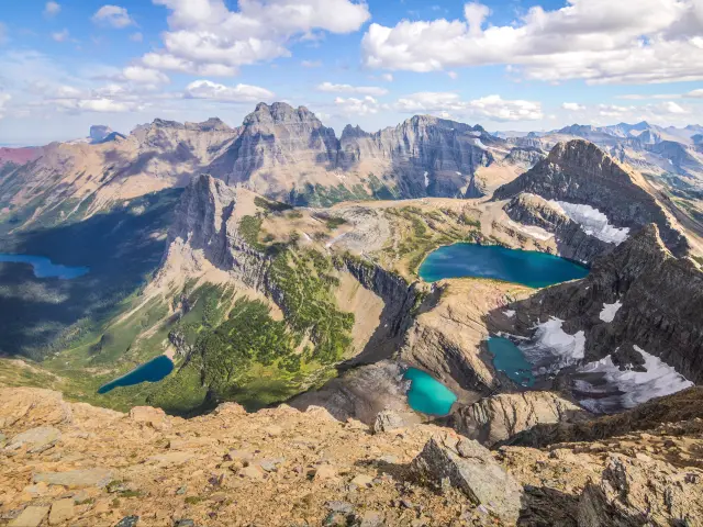 Rare and unique panoramic view from the Belly River Region of Glacier National Park, with snowy mountain range and lakes