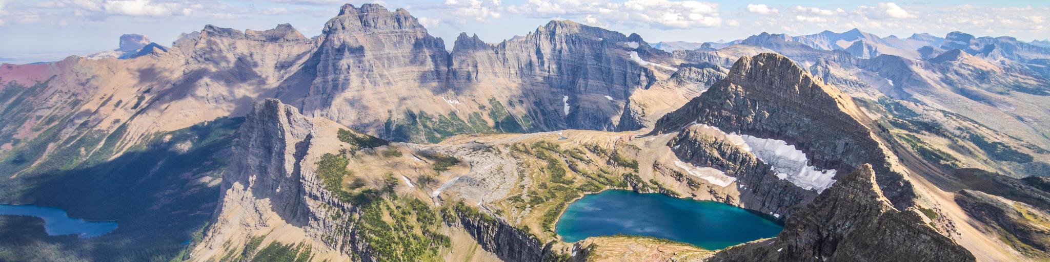 Rare and unique panoramic view from the Belly River Region of Glacier National Park, with snowy mountain range and lakes