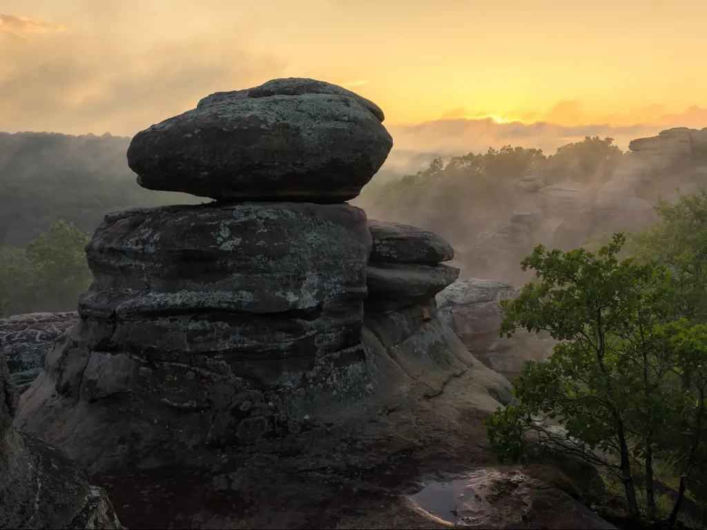 Garden of the God, Shawnee National Forest, Illnois, USA during a scenic summer sunset with rocks in the foreground and mist in the background.