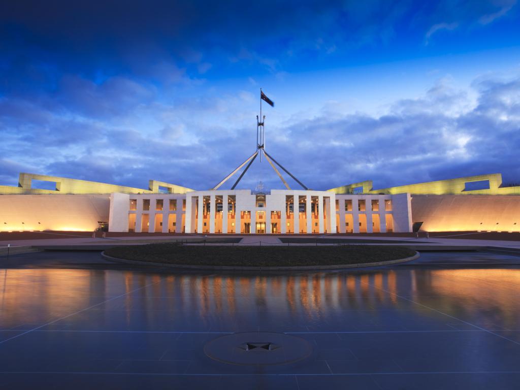 Dramatic evening sky over Parliament House, Canberra, Australia, illuminated at twilight.
