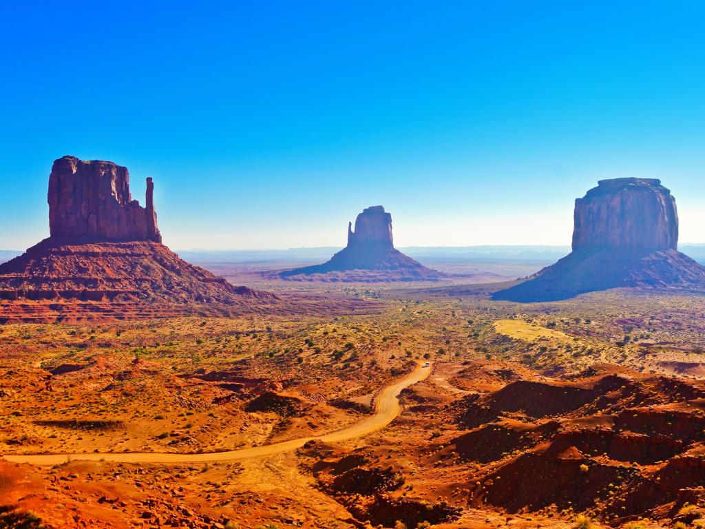 View of Monument Valley on a sunny day near the border of Arizona and Utah in Navajo Nation Reservation in USA.