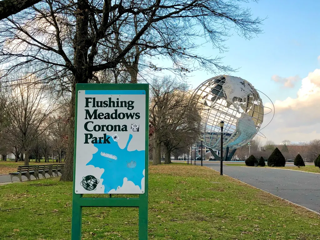 Sign of Flushing Meadows Corona Park with the park in the background