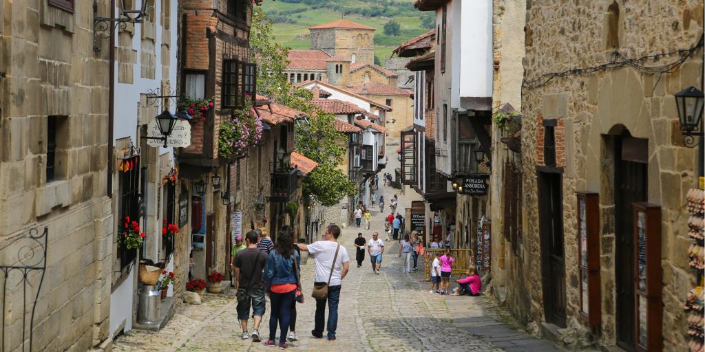 People walking down a narrow street in Santillana del Mar