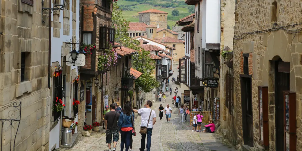 People walking down a narrow street in Santillana del Mar