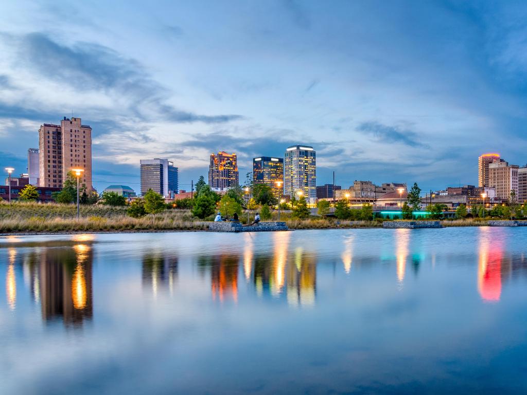 Birmingham, Alabama, USA with the downtown city skyline in the background and reflecting in the water in the foreground taken at early evening.