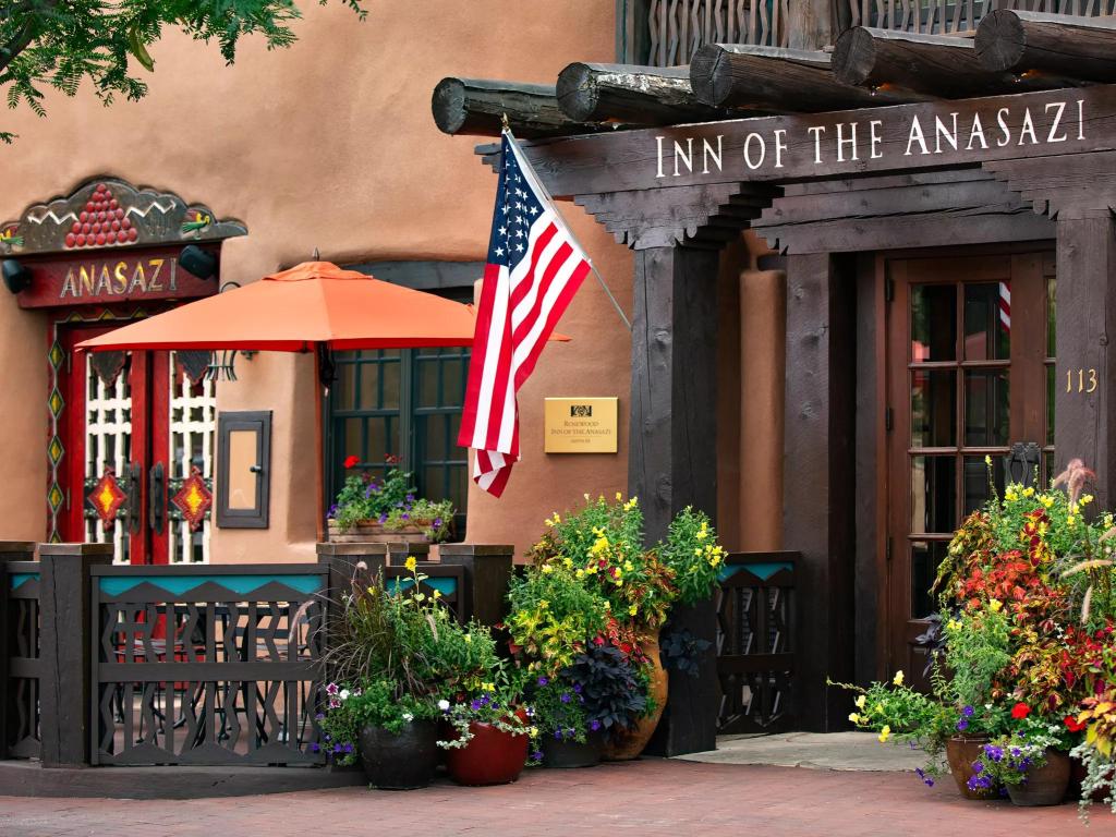 Colorful entrance, with bright flowers and traditional decor, leading to Inn of the Anaseazi, Santa Fe