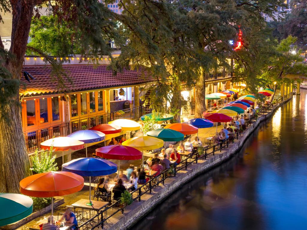 Bright colored umbrellas outside restaurants located across San Antonio River walk