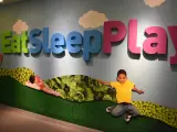Large, bright, Eat, Sleep and Play sign at entrance to Children's Museum of Manhattan in New York
