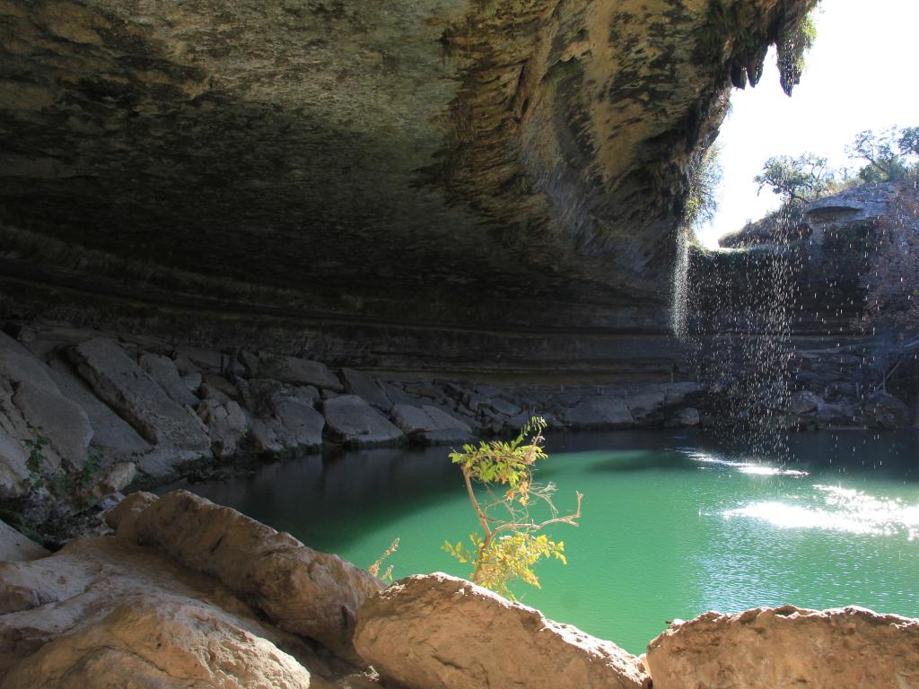 Dripping Springs, Texas, USA taken at Hamilton Pool Preserve with the cave surrounding the turquoise water.