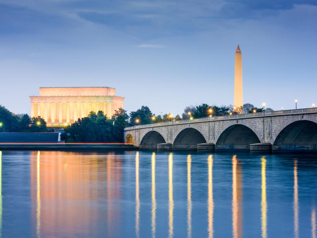 Washington DC, USA with the skyline on the Potomac River with Lincoln Memorial, Washington Monument, and Arlington Memorial Bridge at night.