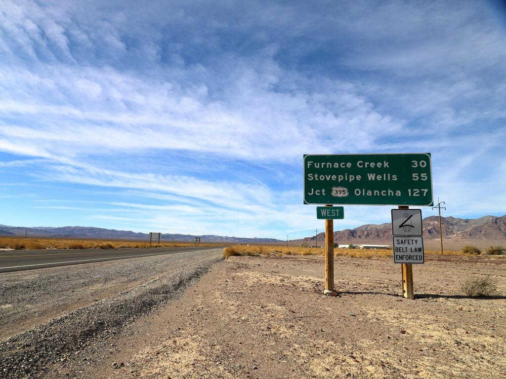Mileage sign at the Death Valley Junction, cloudy day