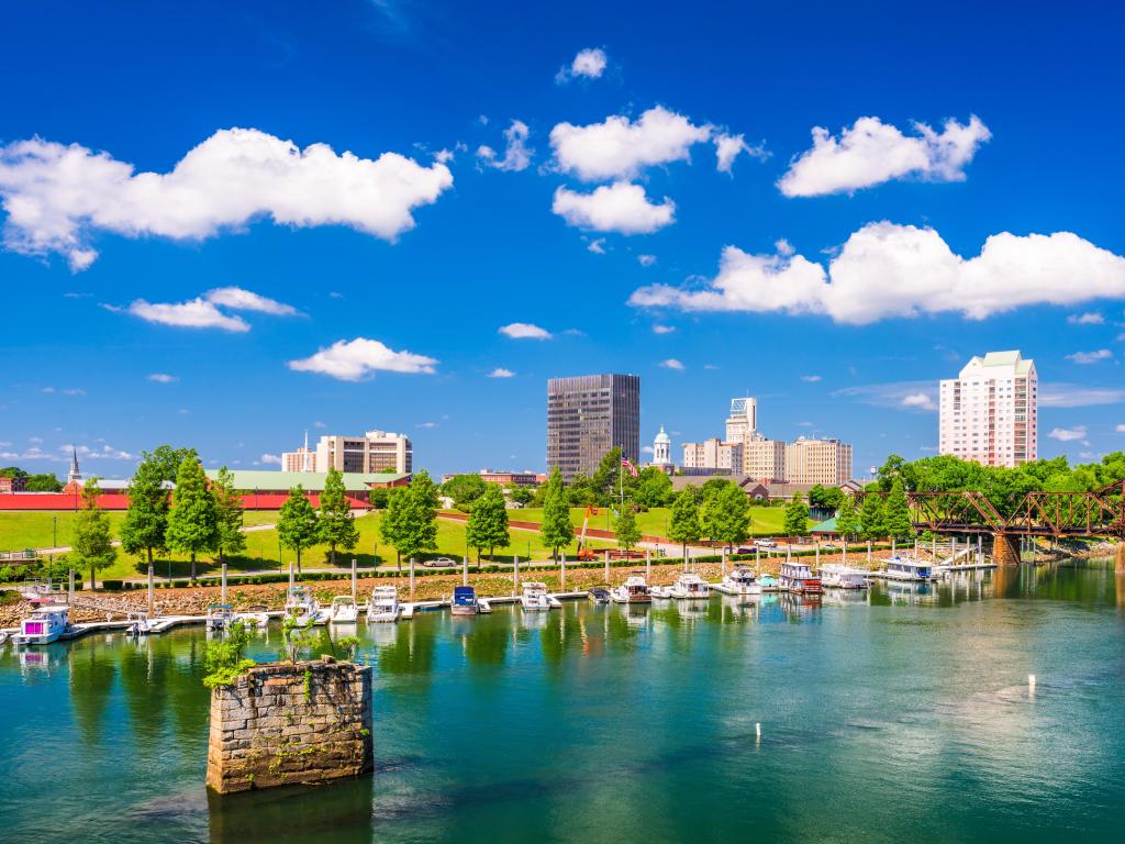 Augusta, Georgia, USA taken at downtown with the city skyline in the background and boats on the river in the foreground, taken on a clear sunny day.