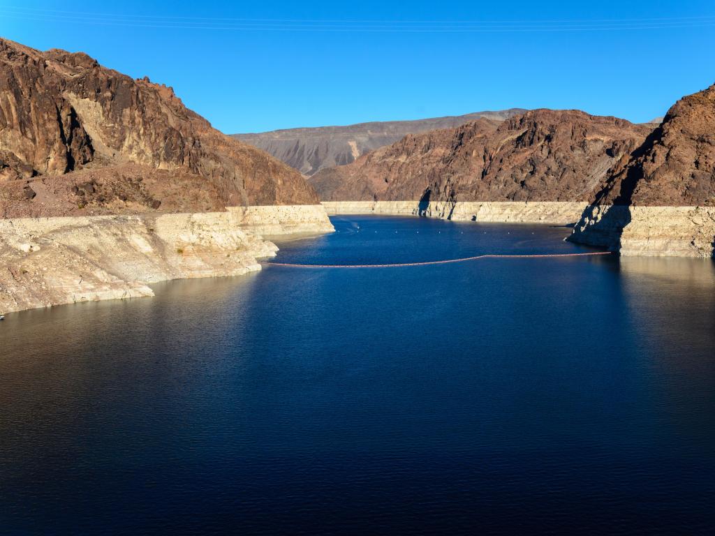 Hoover Dam, Boulder City, USA with a view of the Colorado River on a sunny day.