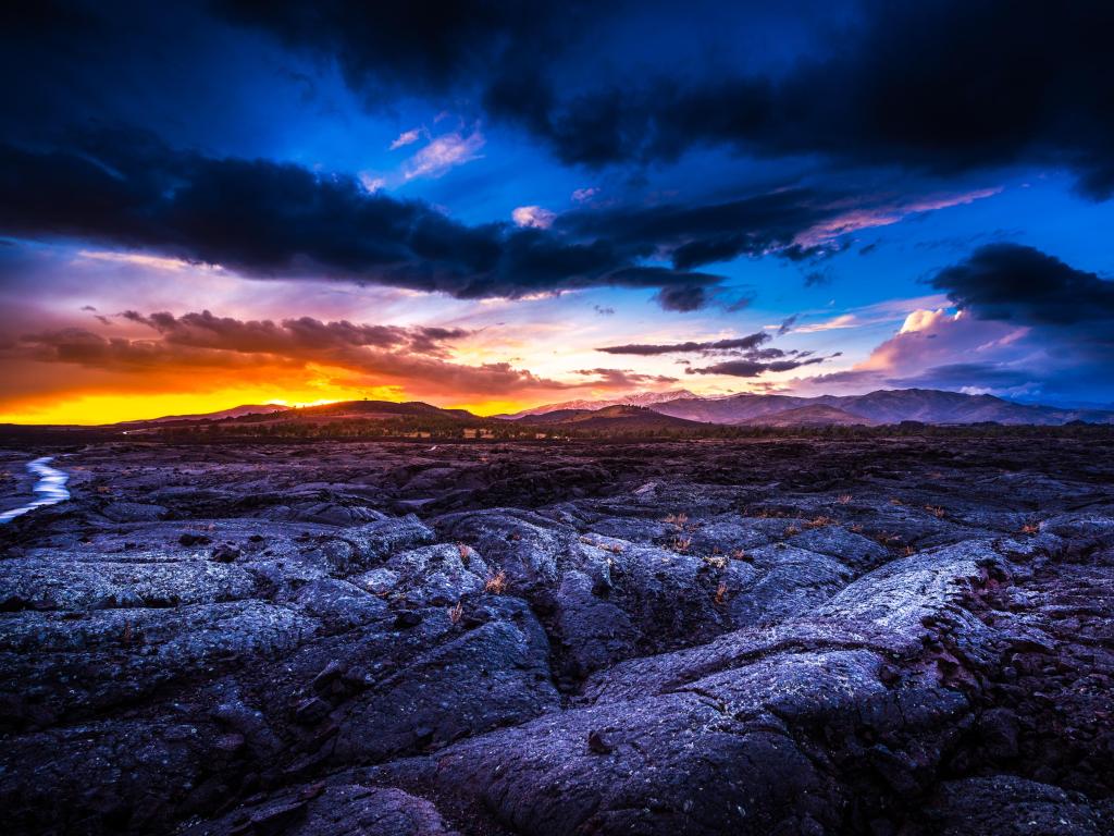 Sunset Crater of the Moon National Preserve, Arco, Idaho, USA taken at sunset with dramatic skies above a rocky terrain. 