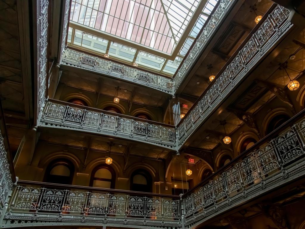 Low angle view of balconies around the atrium of Beekman Hotel, with neo-Grec and Renaissance Revival styles