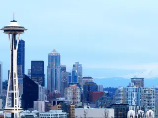 Seattle Skyline and Mount Rainier, Washington, USA with a view of the Space Needle, skyline and Mount Rainier from Kerry Park on a clear blue day.