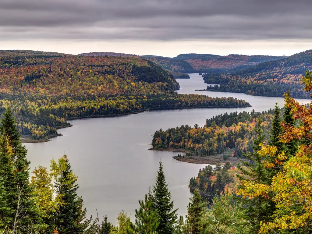Lake surrounded by a forest with autumn leaves in La Mauricie National Park in Quebec, Canada.
