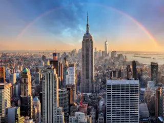 Full view of the Empire State Building with rainbow in the background