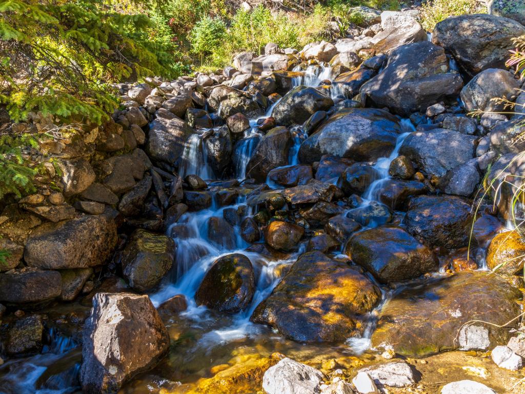 Serene waterfall cascading through round rocks